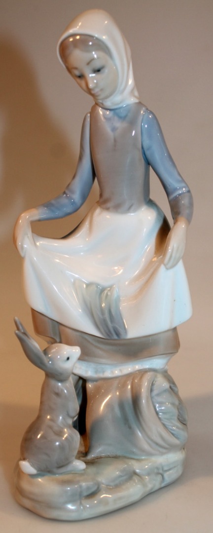 Appraisal: A thC Lladro figure of a maid seated aside hare