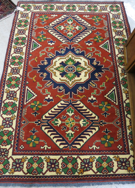 Appraisal: HAND KNOTTED ORIENTAL AREA RUG Pakistani-Caucasian three geometric medallion and