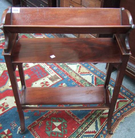 Appraisal: An Edwardian mahogany three tier book trough raised on splayed