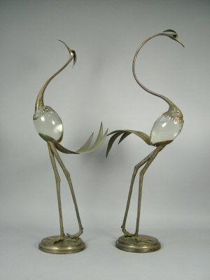 Appraisal: A pair of Italian wrought metal and glass stylized figural