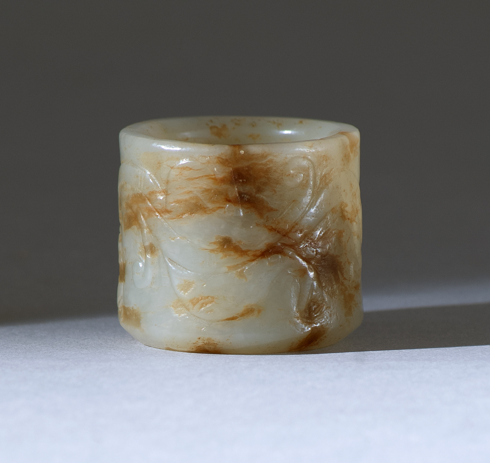 Appraisal: RUSSET AND GRAY JADE THUMB RING th CenturyWith relief dragon