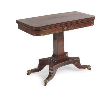 Appraisal: A Regency rosewood and brass inlaid card table the foldover