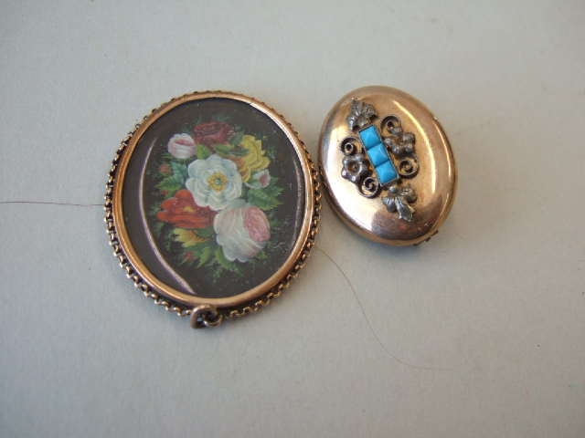 Appraisal: An oval pendant locket glazed with a floral miniature painting