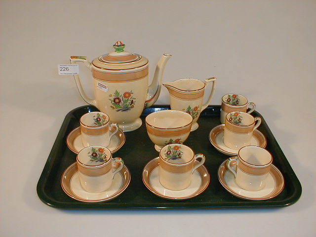 Appraisal: A Mintons coffee set cream with brown banding and polychrome