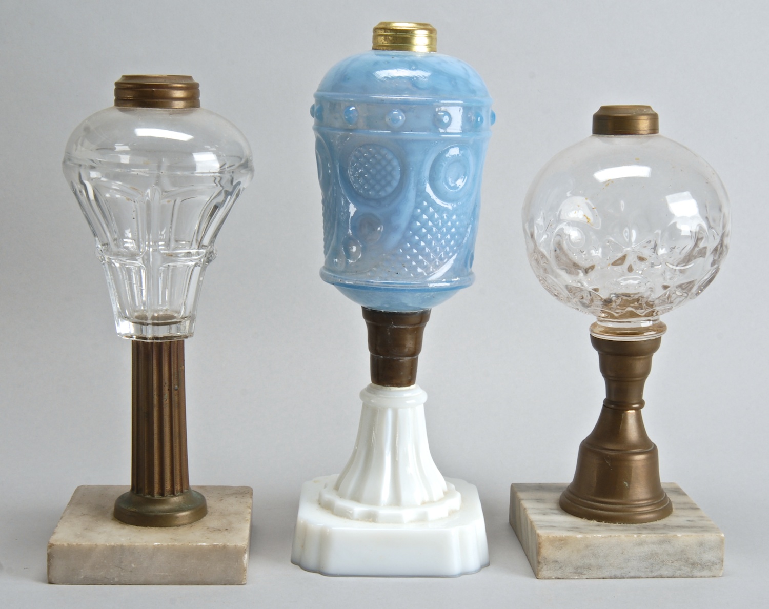 Appraisal: THREE GLASS FLUID LAMPS two late th Century with clear