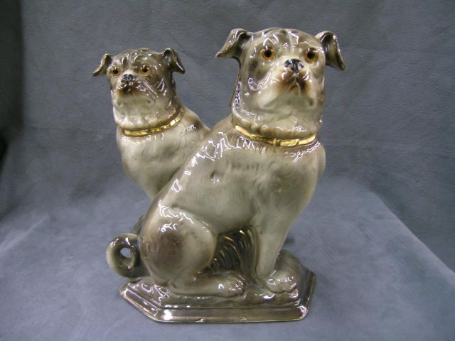 Appraisal: Pair of large Staffordshire pugs on angular bases and bright