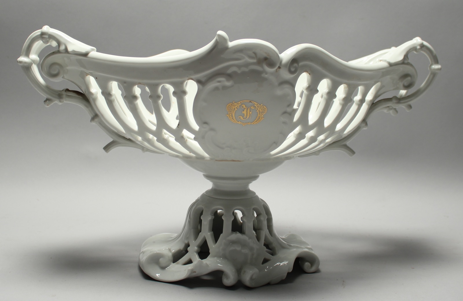 Appraisal: PARIS PORCELAIN TWO-HANDLED FENESTRATED COMPOTE th CenturyIn white glaze Gilt