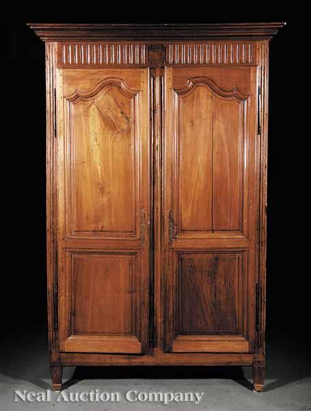 Appraisal: An Antique Louis XVI-Style Carved Fruitwood Armoire th c stepped