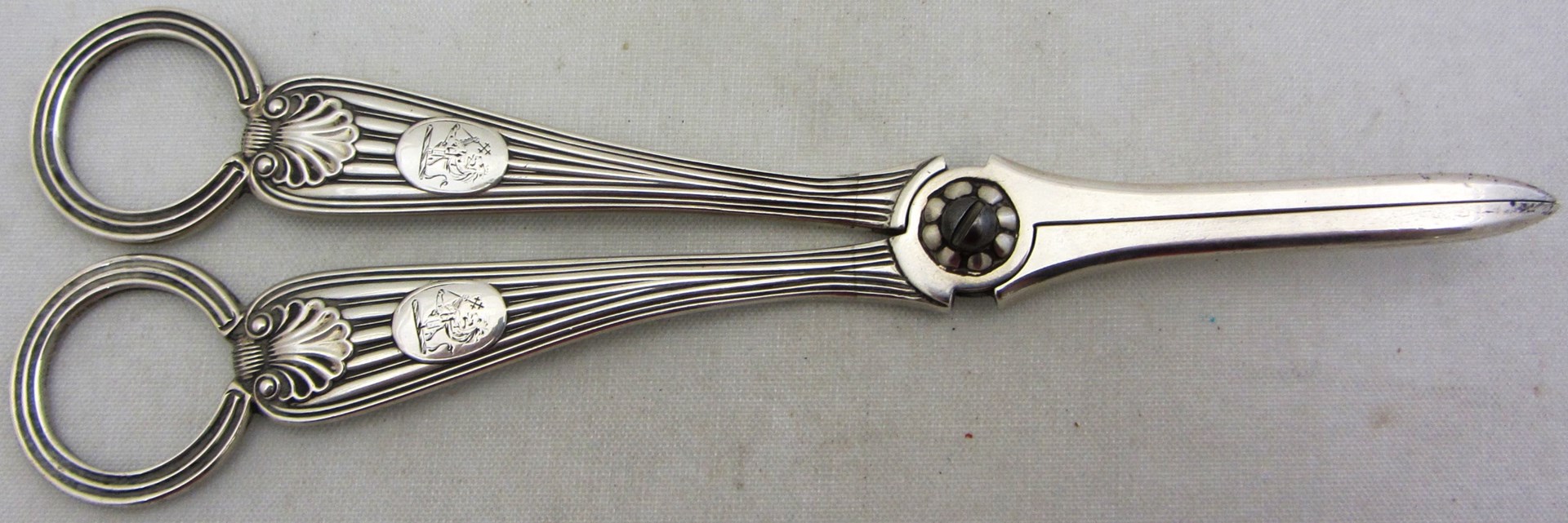 Appraisal: A pair of Victorian silver scissor action grape scissors crest