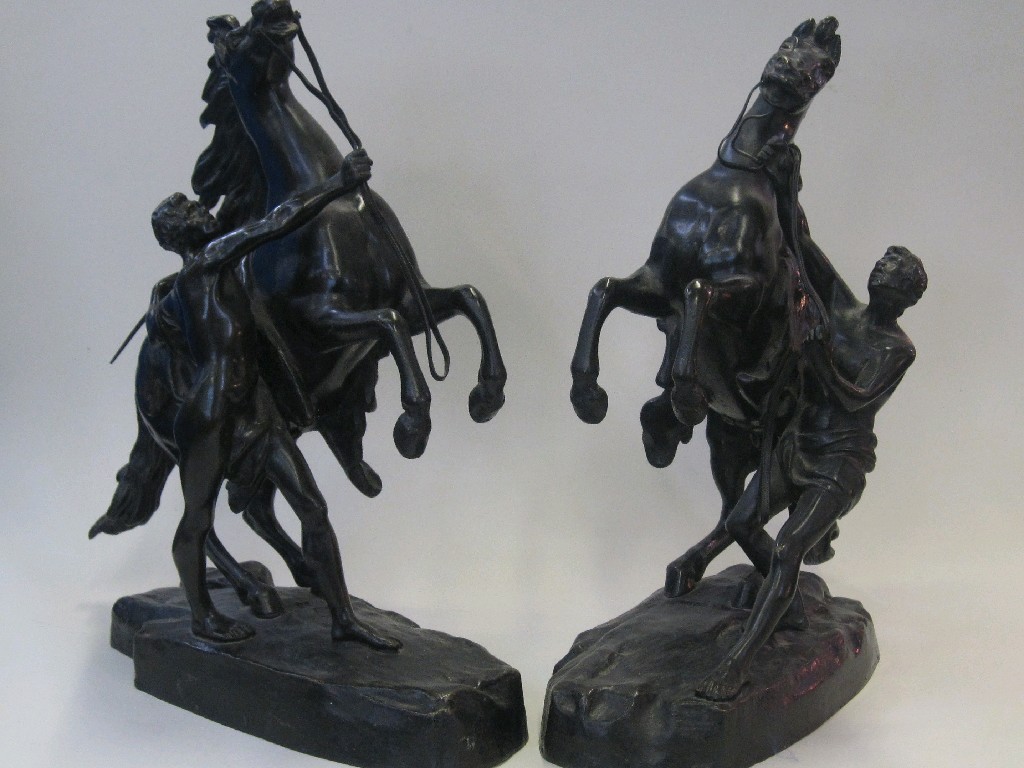 Appraisal: After Cousteau a pair of bronze Marli horses with attendants