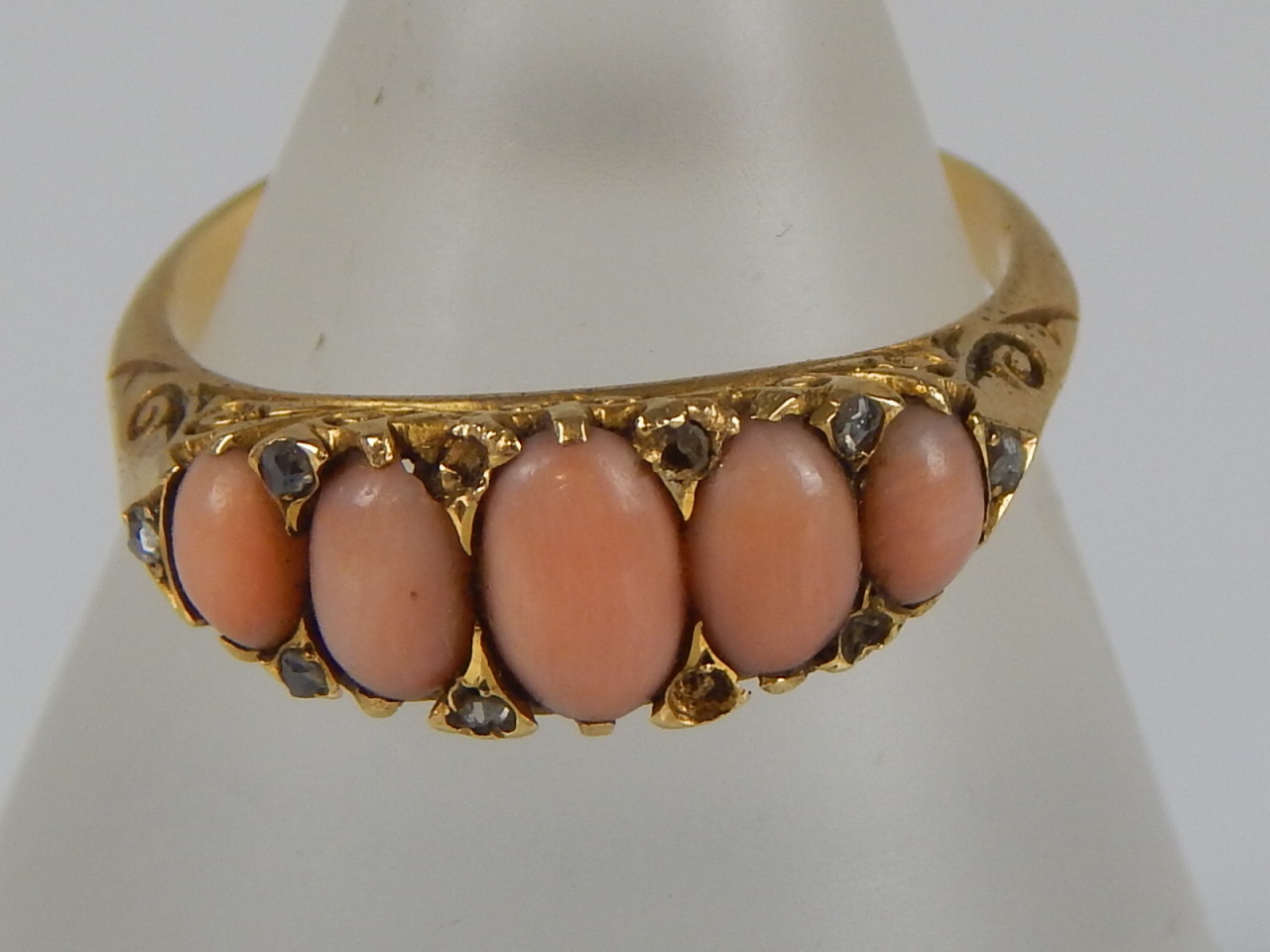 Appraisal: An ct gold coral and diamond gypsy ring with five