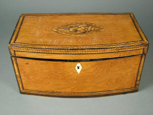 Appraisal: A George III bow fronted satinwood tea caddy with crossbanded