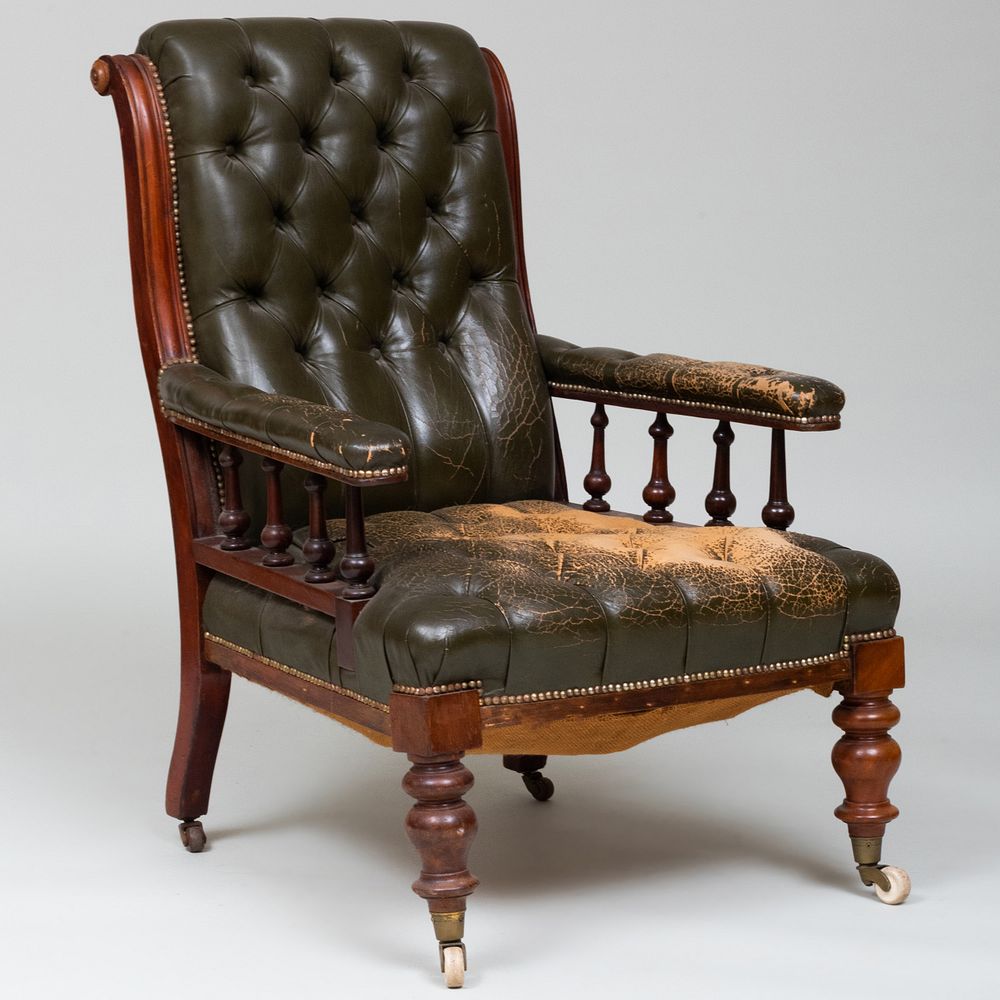 Appraisal: Early Victorian Leather Tufted Upholstered Armchair Fitted with porcelain casters