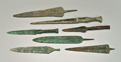 Appraisal: Seven ancient bronze daggers or spear points probably Luristan probably