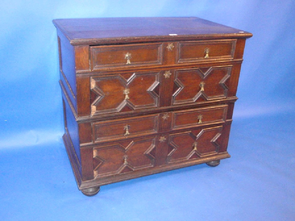 Appraisal: A Jacobean style oak chest of four drawers with brass