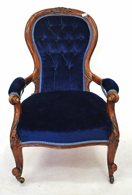 Appraisal: A VICTORIAN WALNUT OPEN ARMCHAIR with carved cresting rail to