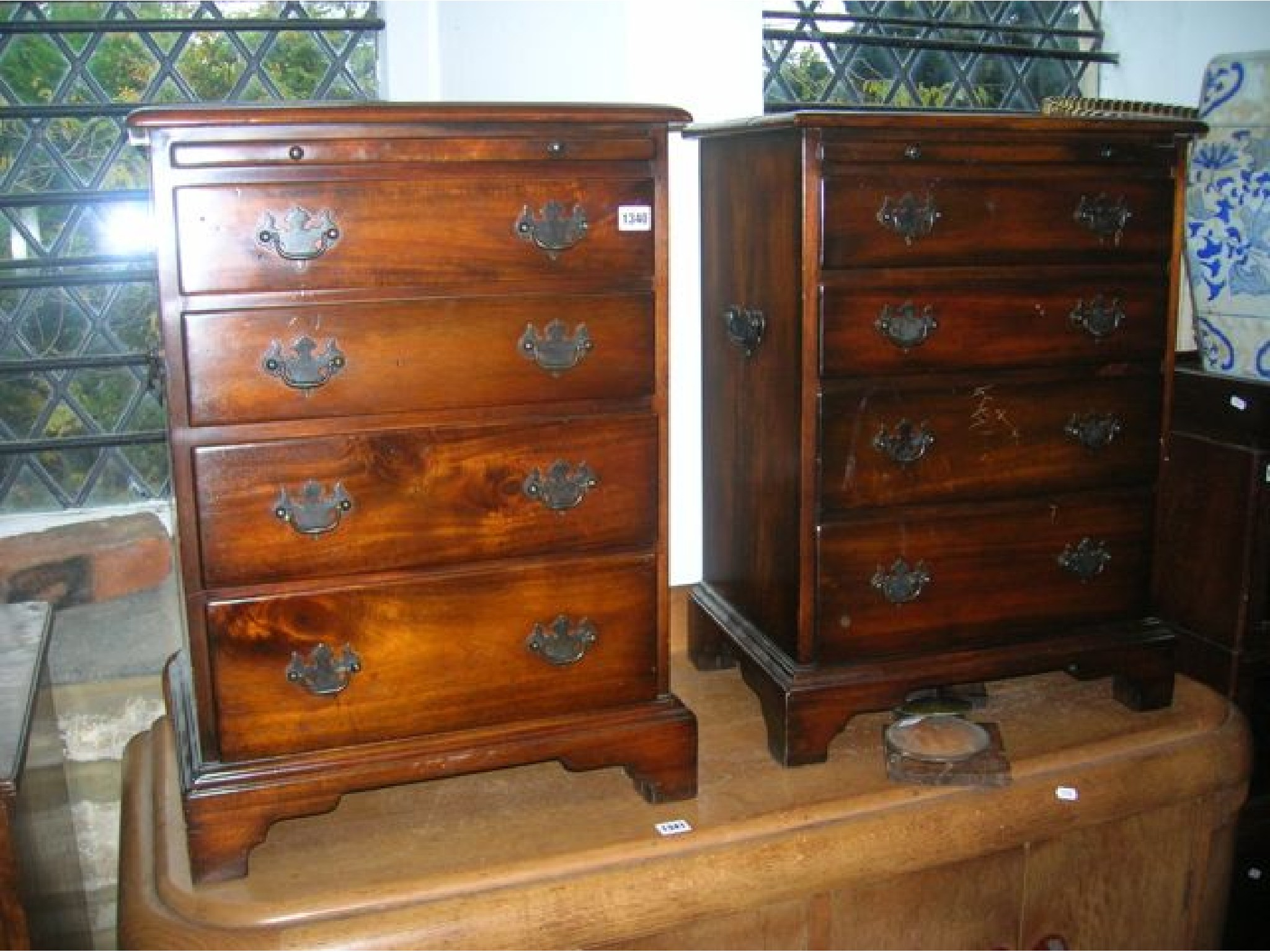 Appraisal: A pair of small good quality reproduction four drawer graduated