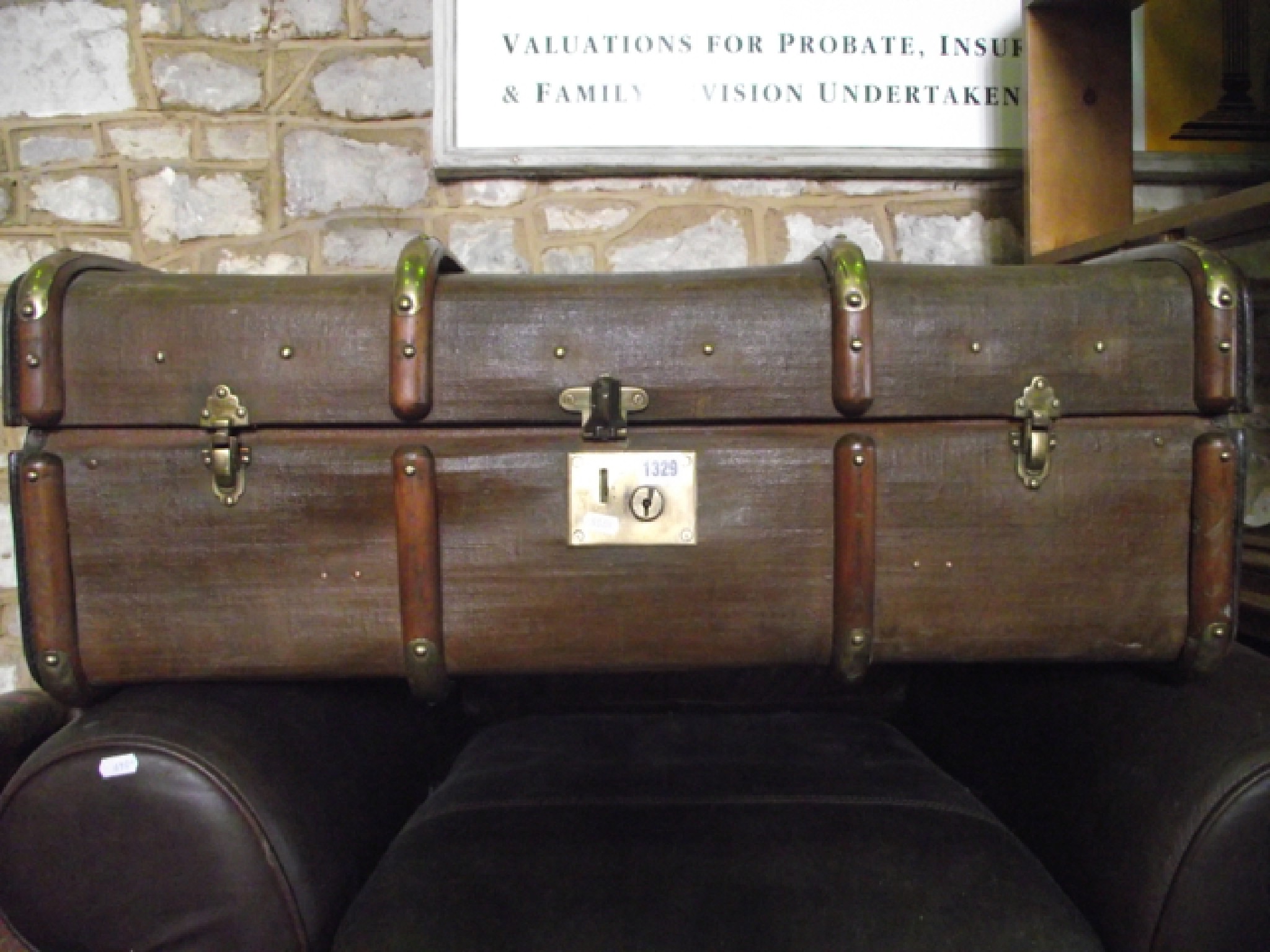 Appraisal: A canvas trunk with beechwood lathes and polished brass fittings