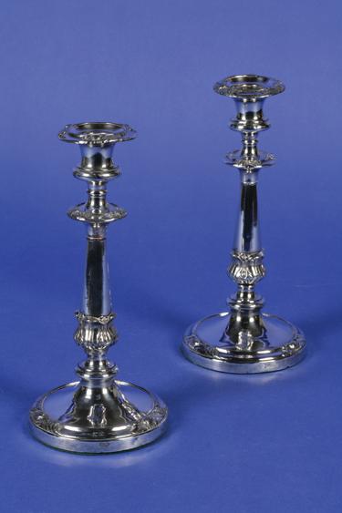 Appraisal: A PAIR OF VICTORIAN CANDLESTICKS with tapering stems applied with