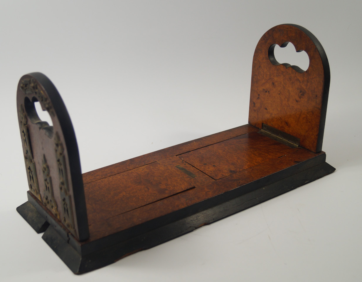 Appraisal: A Victorian walnut and ebonised book slide with Gothic brass