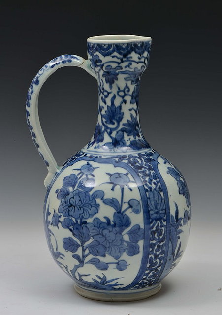 Appraisal: A JAPANESE ARITA BLUE AND WHITE JUG with panels of