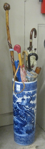 Appraisal: CANE AND UMBRELLA COLLECTION IN PORCELAIN UMBRELLA STAND featuring a