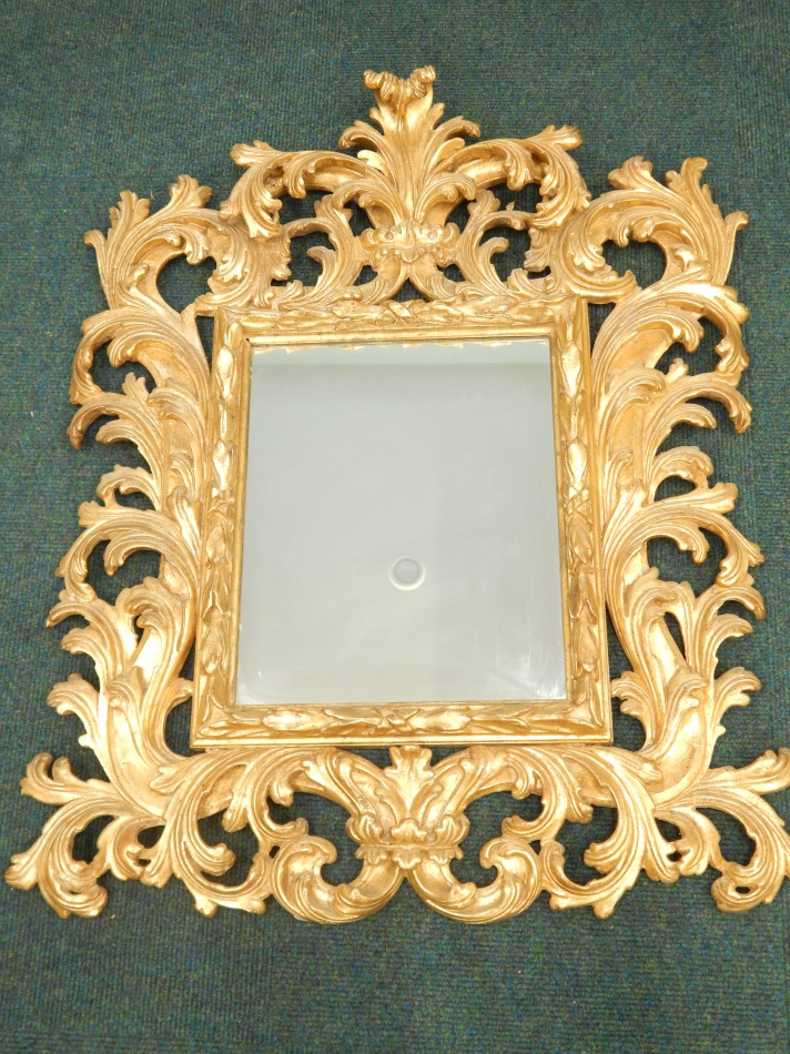 Appraisal: A Continental giltwood Florentine type wall mirror the elaborate frame