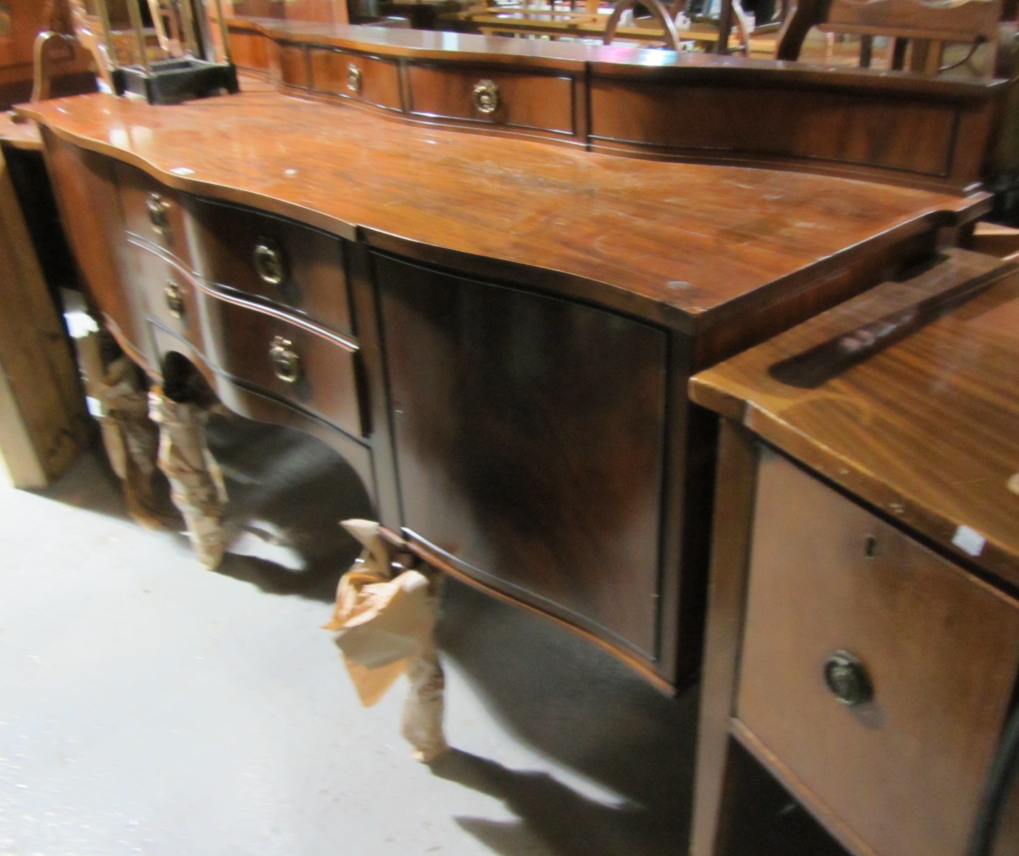 Appraisal: A th century mahogany serpentine fronted sideboard