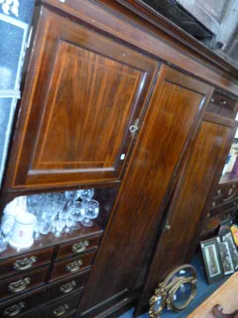 Appraisal: A LATE VICTORIAN TRIPLE WARDROBE by Maple Co Ltd the