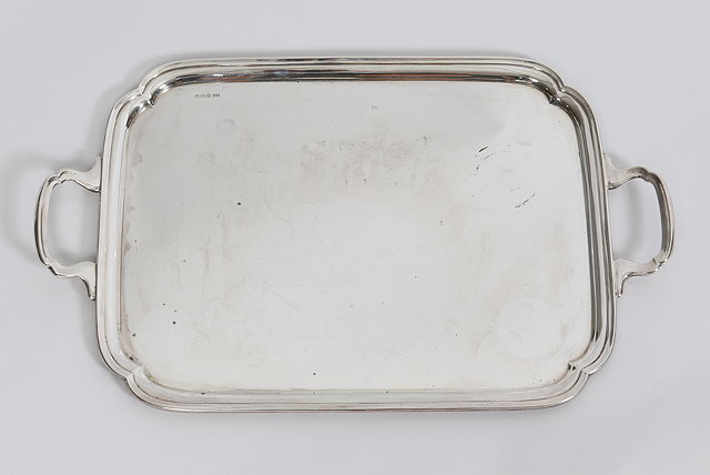 Appraisal: A RECTANGULAR SILVER TRAY with re-entrant corners and cast loop