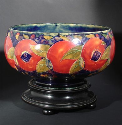 Appraisal: Pomegranate' a large Moorcroft Pottery bowl and ebonised wood stand