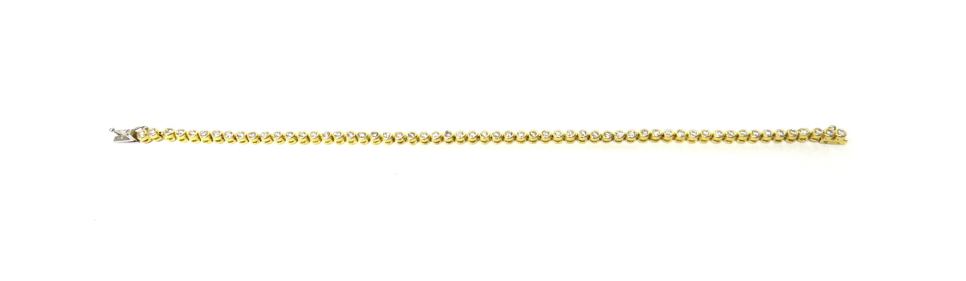 Appraisal: A gold and diamond set line bracelet collet set with