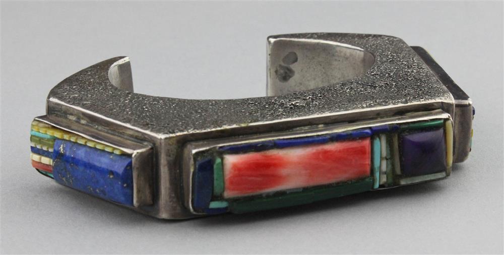 Appraisal: SILVER CUFF WITH GEOMETRIC INLAYS OF TURQUOISE SUGILITE CORAL LAPIS