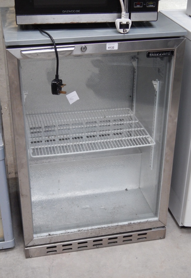 Appraisal: A Blizzard silver finished undercounter fridge