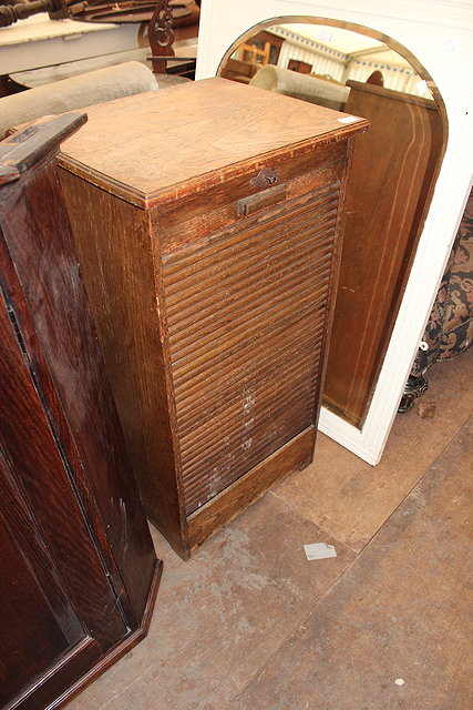 Appraisal: AN OAK TAMBOUR FRONTED FILING CABINET approximately cm wide