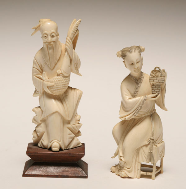 Appraisal: Two Asian carved ivory figures of a fisherman and a