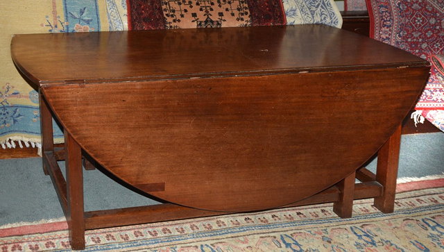 Appraisal: A GEORGE III MAHOGANY WAKE TABLE with oval drop-flap top