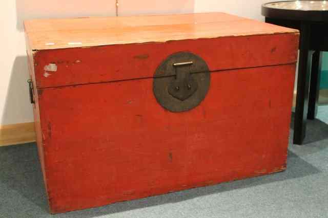 Appraisal: A CHINESE RED LACQUER TRUNK with iron lock across