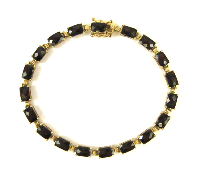 Appraisal: GARNET AND TEN KARAT YELLOW GOLD BRACELET measuring inches in