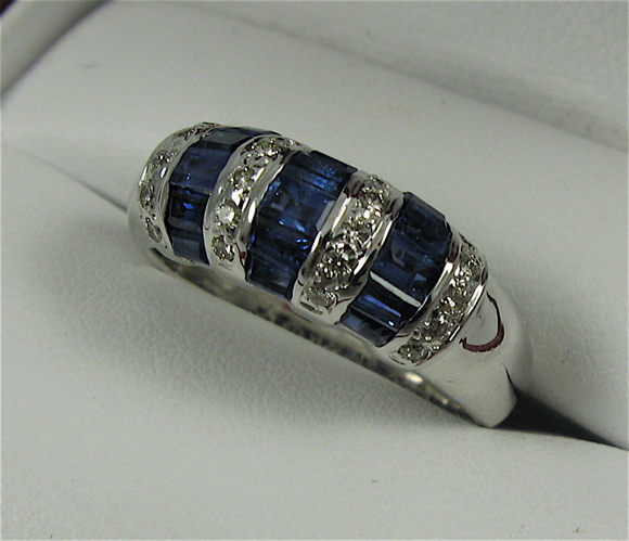 Appraisal: SAPPHIRE DIAMOND AND K WHITE GOLD RING set with baguette