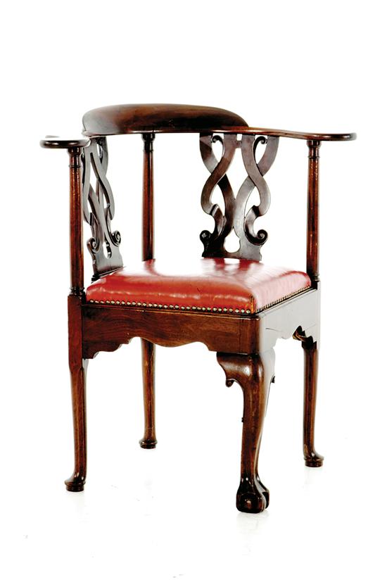 Appraisal: George III carved mahogany corner chair circa continuous arm with