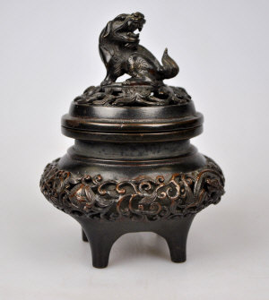 Appraisal: A Chinese bronze incense burner and cover unusual reticulated casting