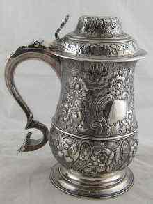 Appraisal: A Georgian silver baluster tankard with high dome lid scroll