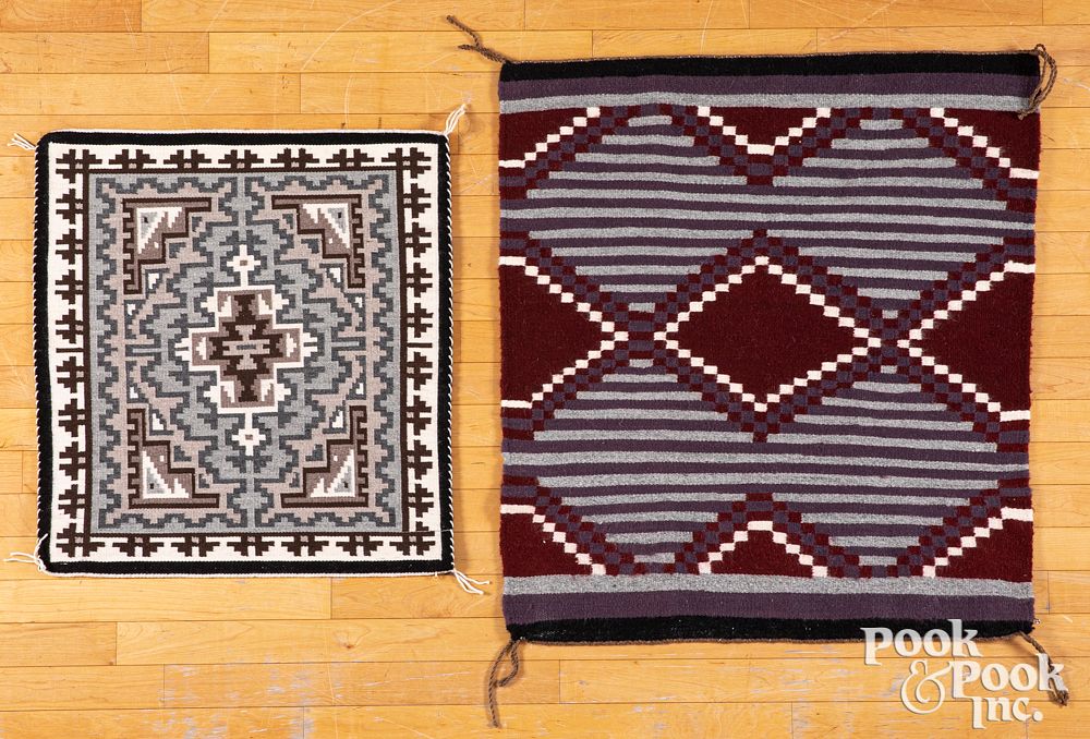 Appraisal: Two saddle blanket-sized Navajo rugs Two saddle blanket-sized Navajo rugs