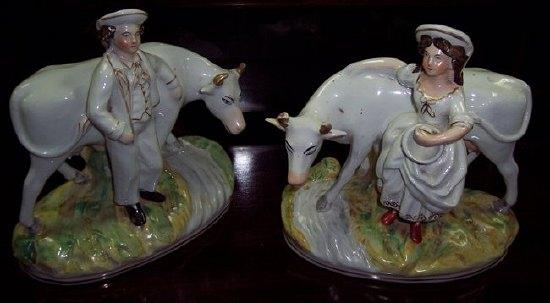 Appraisal: A pair of Staffordshire figures of a cowherd and milkmaid