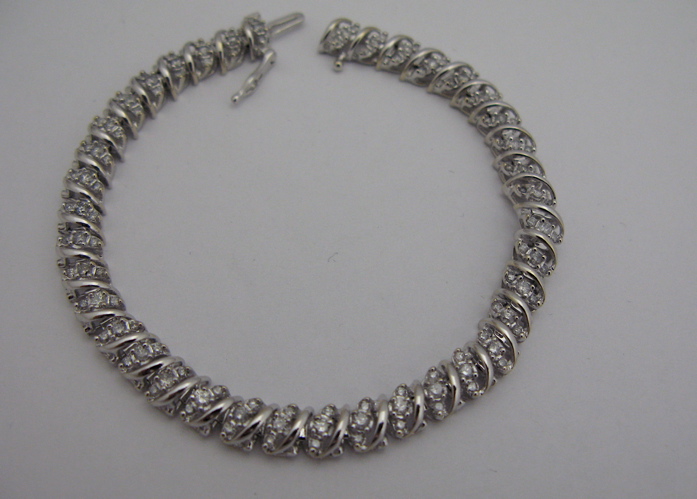 Appraisal: DIAMOND AND KARAT WHITE GOLD BRACELET with round-cut diamonds together