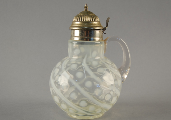 Appraisal: A Unattributed Molded Glass Syrup Pitcher with an opalescent coin