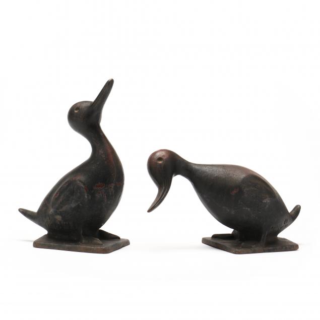 Appraisal: VIRGINIA METALCRAFTERS TWO CAST IRON DUCK DOORSTOPS Circa cast iron