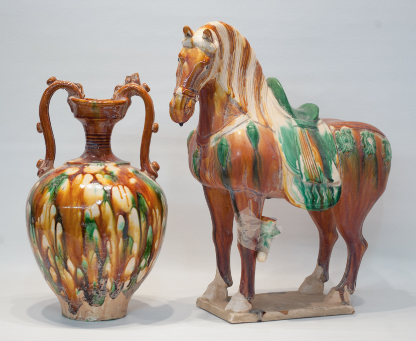 Appraisal: CHINESE SCANCAI GLAZED POTTERY HORSE AND URN Tang Dynasty style