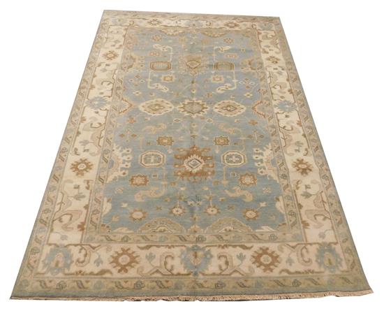 Appraisal: RUG Oushak light blue field with wide cream border accents